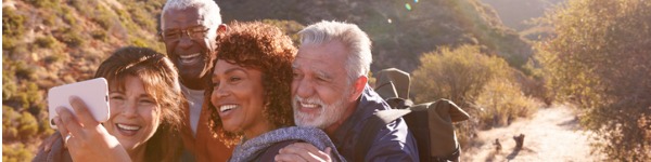 group-of-senior-friends-posing-for-selfie-as-they-hike-along-trail-in-picture-id1223351863