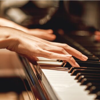 favorite-classical-musicclose-up-view-of-gentle-female-hands-playing-picture-id1129332575