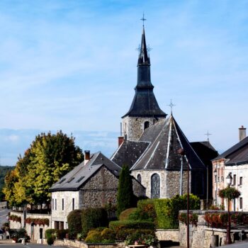 Eglise Saint Lambert and Flowered Street against Blue Sky Outdoors. Hargnies, France