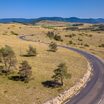 Sealed Winding road through calcareous limestone karst landscape of Causse Noir in Cevennes France